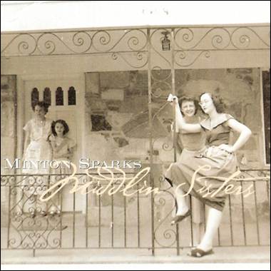 A group of women sitting on a railing
Description automatically generated
