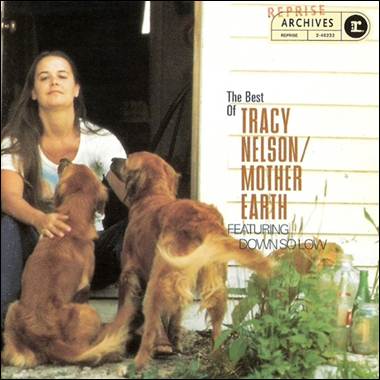 A person sitting in front of a door with two dogs
Description automatically generated