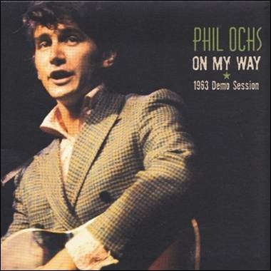 A person in a suit holding a guitar
Description automatically generated