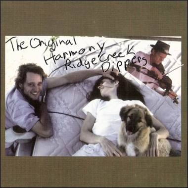 A group of people lying in bed with a dog and a violin
Description automatically generated