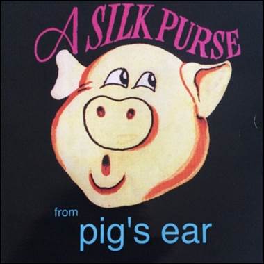 A pig face on a black background
Description automatically generated