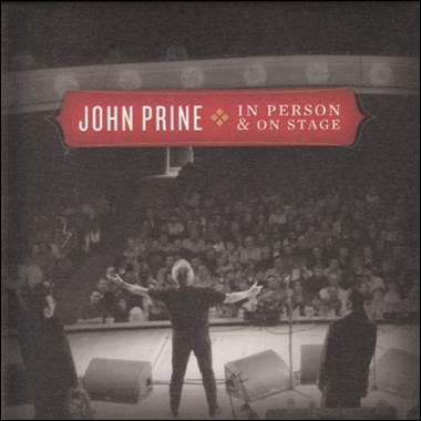 A person on stage with a crowd of people
Description automatically generated