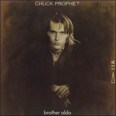 A person with long hair and a black jacket
Description automatically generated