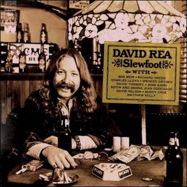 A person sitting at a table with money and a sign
Description automatically generated