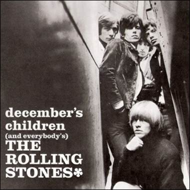 A group of men leaning against a wall
Description automatically generated