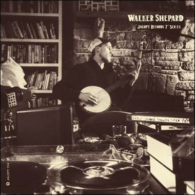 A person playing a banjo in a room
Description automatically generated