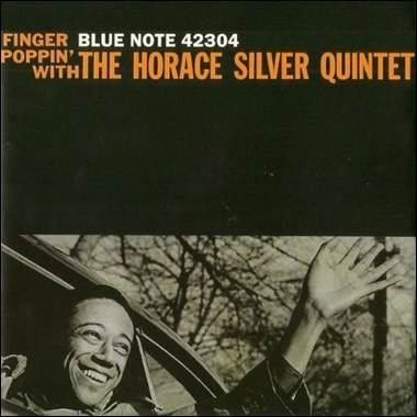 A person waving in a car
Description automatically generated