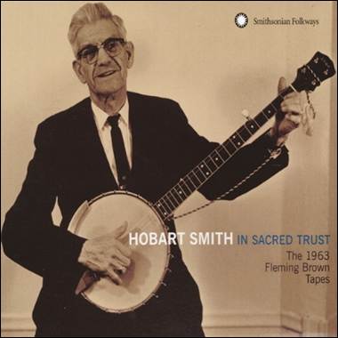 A person in a suit playing a banjo
Description automatically generated