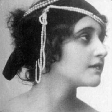 A person with a pearl headband
Description automatically generated