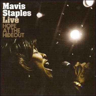 A person singing into a microphone
Description automatically generated