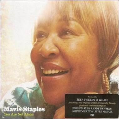 A person smiling with a card
Description automatically generated