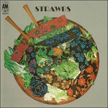 A bowl of strawberries on a grey background
Description automatically generated