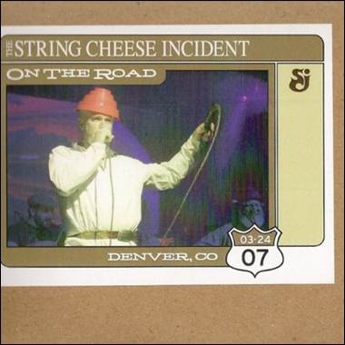 A person wearing a helmet and holding a microphone
Description automatically generated