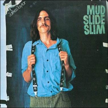 A person with long hair wearing suspenders
Description automatically generated