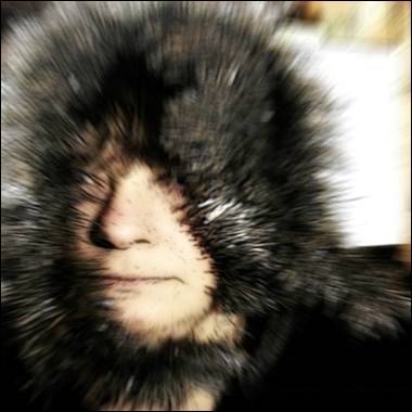 A person with furry hat

Description automatically generated