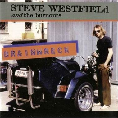 A person standing next to a motorcycle
Description automatically generated