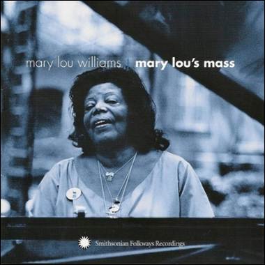 A person standing behind a piano
Description automatically generated