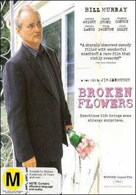 A person in a suit holding a flower

Description automatically generated