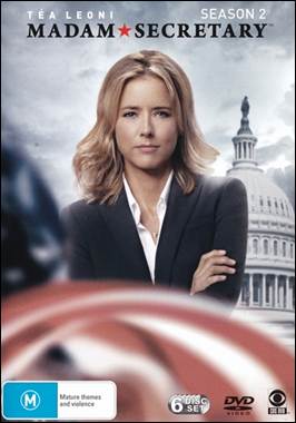 A person in a suit with her arms crossed

Description automatically generated