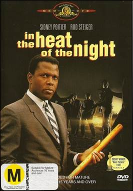 A person in a suit holding a bat

Description automatically generated