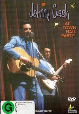 A person holding guitars and a microphone

Description automatically generated