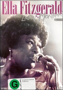 A person singing into a microphone
Description automatically generated