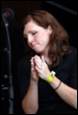 A person praying with her hands together

Description automatically generated